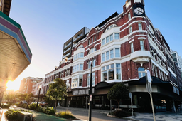 Photo from Newcastle CBD of an old building and walkable streets and crossing.