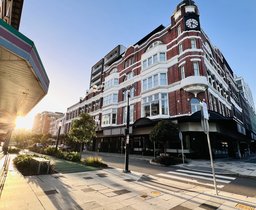 Photo from Newcastle CBD of an old building and walkable streets and crossing.